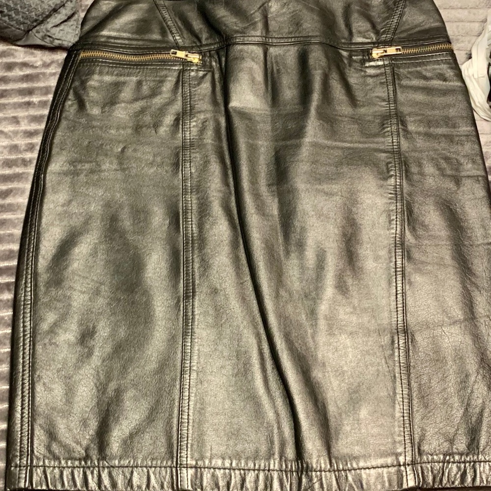 Black genuine leather skirt with zippers.
